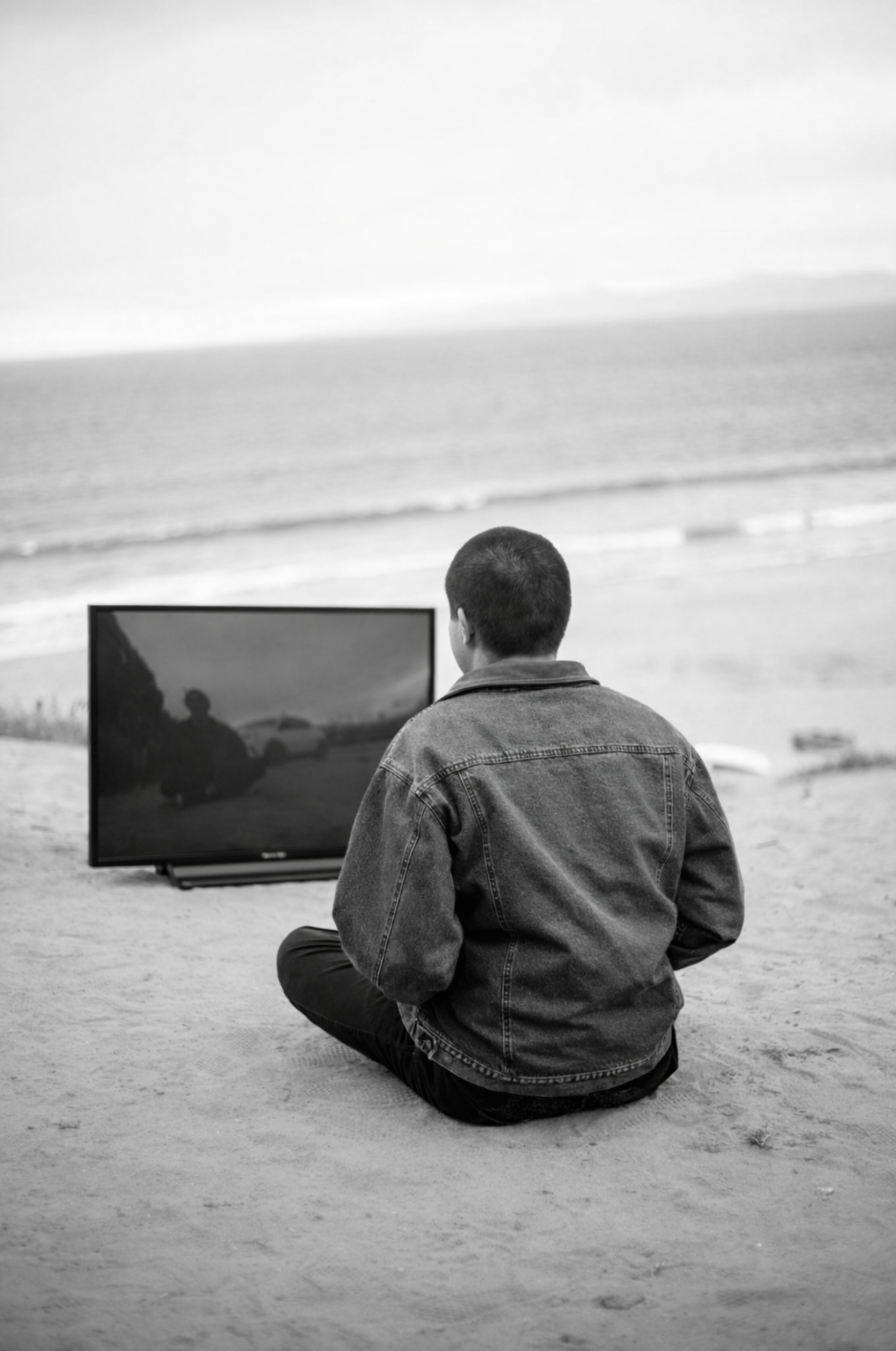 Man on beach with TV